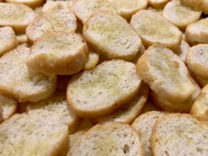 1/4 inch baguette slices drizzled with olive oil and toasted