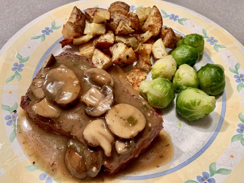 Roasted Rosemary Potatoes as a side dish with Steak covered in Marsala Mushroom Gravy and Brussel Sprouts.